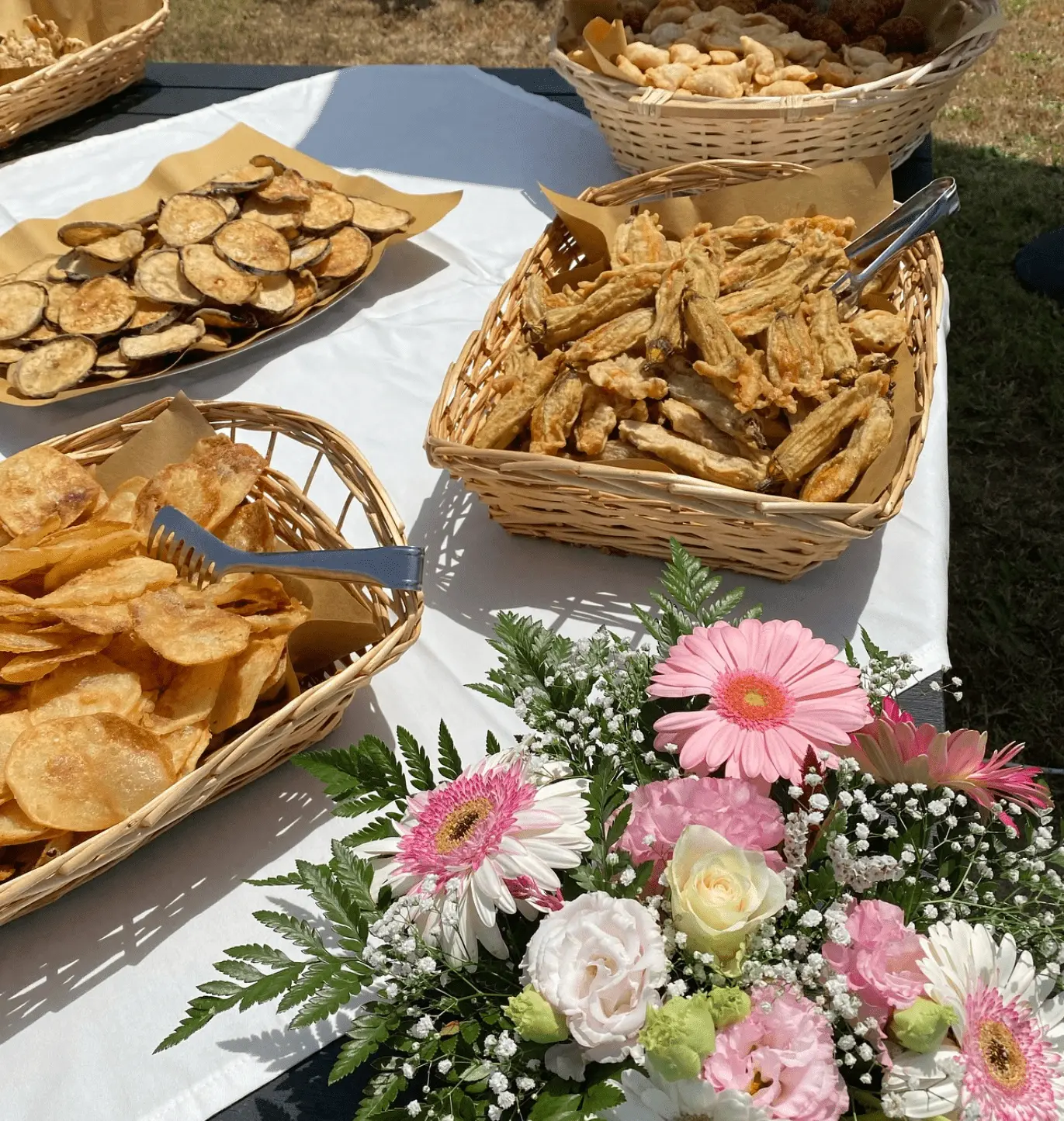 Elegant buffet presentation with fresh flowers and rustic baskets