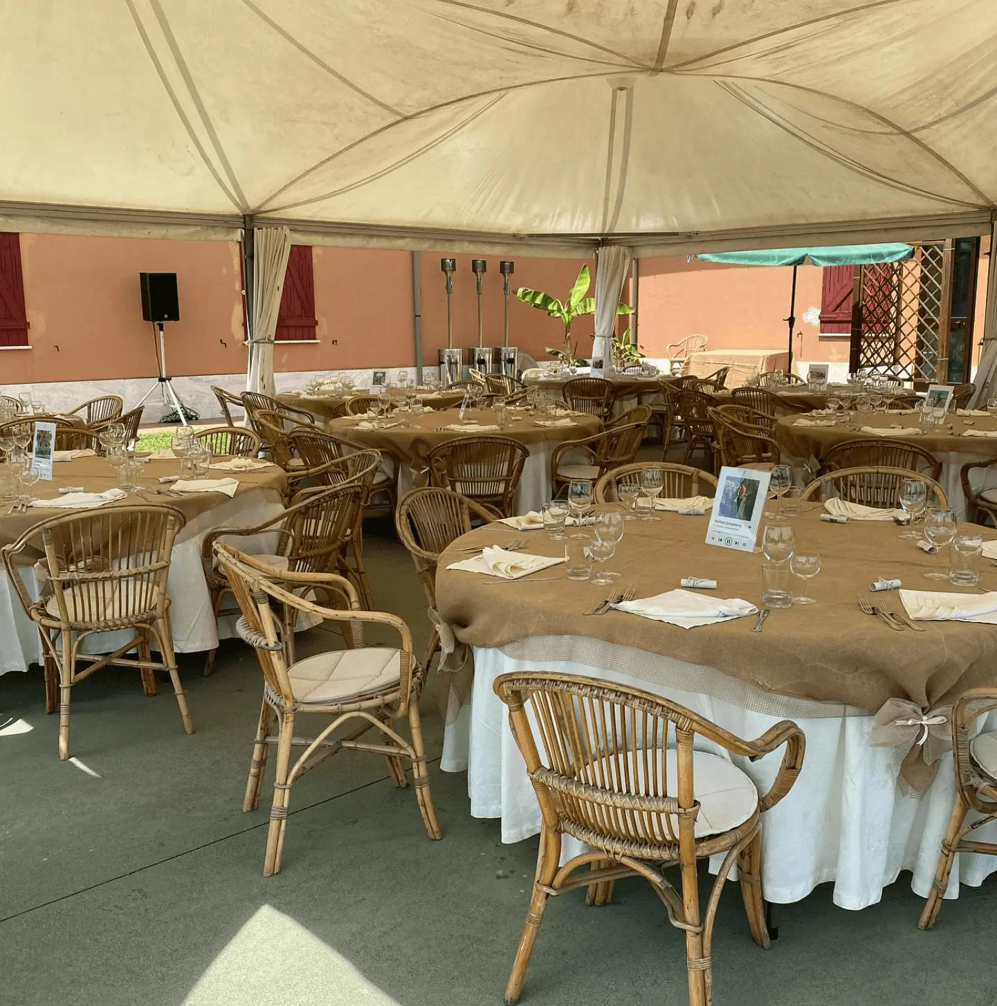 Wedding reception setup under tent with rustic table arrangements
